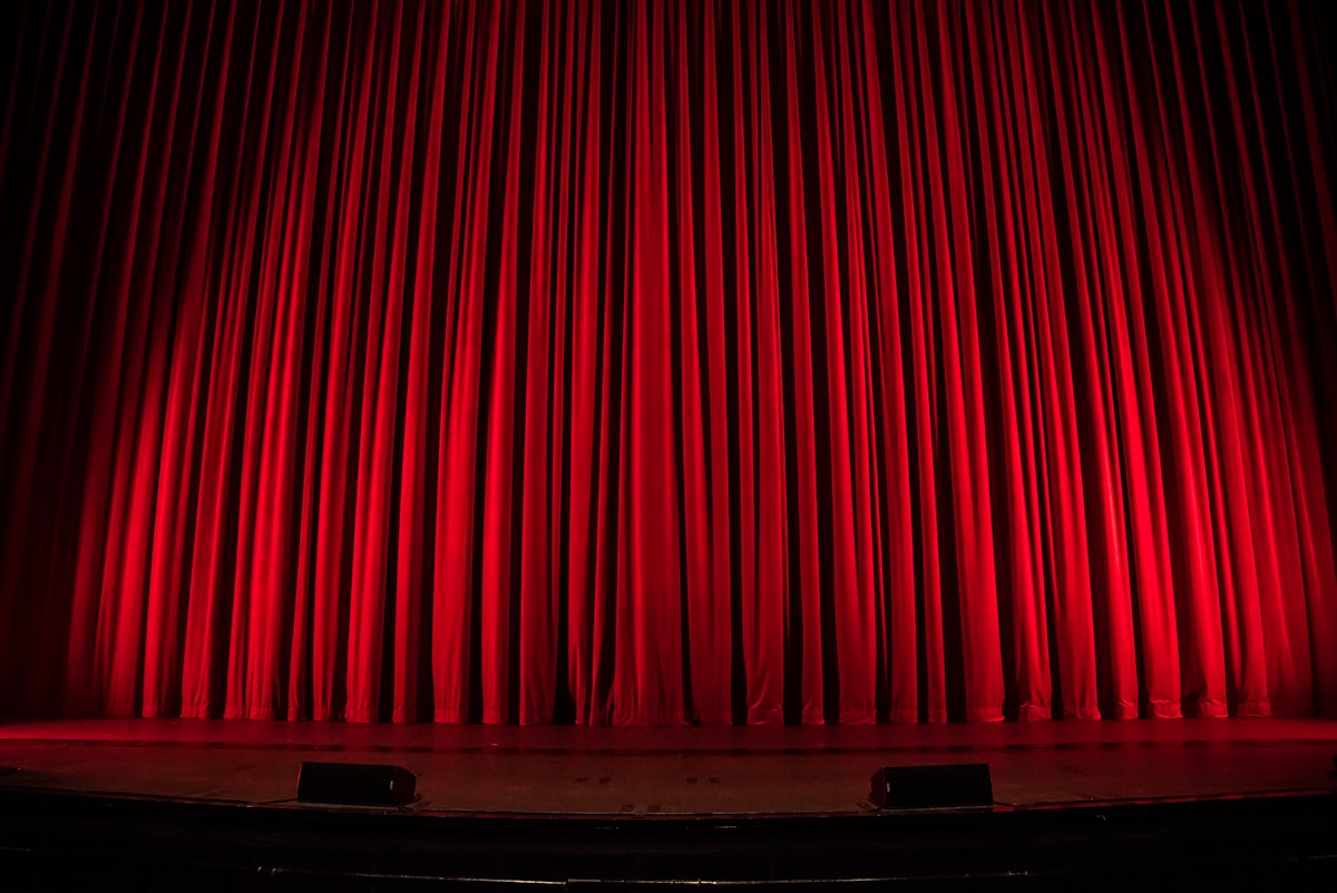 Theater spotlight on a red stage curtain